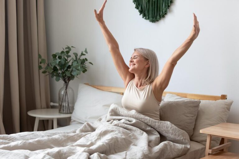 Mulher acordando feliz após utilizar aparelho CPAP